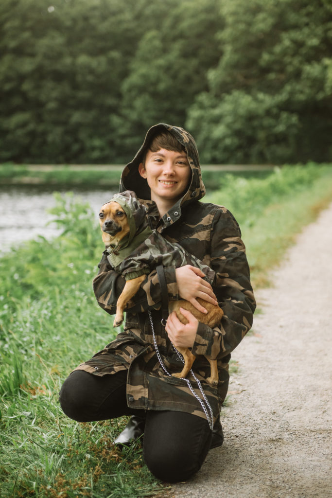 Danielle holding Milo, donning matching camo hoodies.